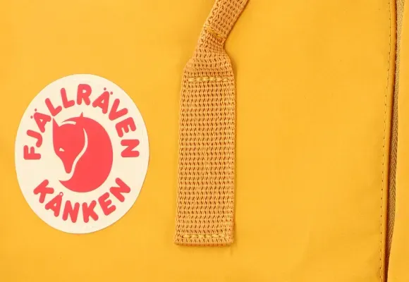 Close-up of Yellow Kånken Backpack Logo and Strap
